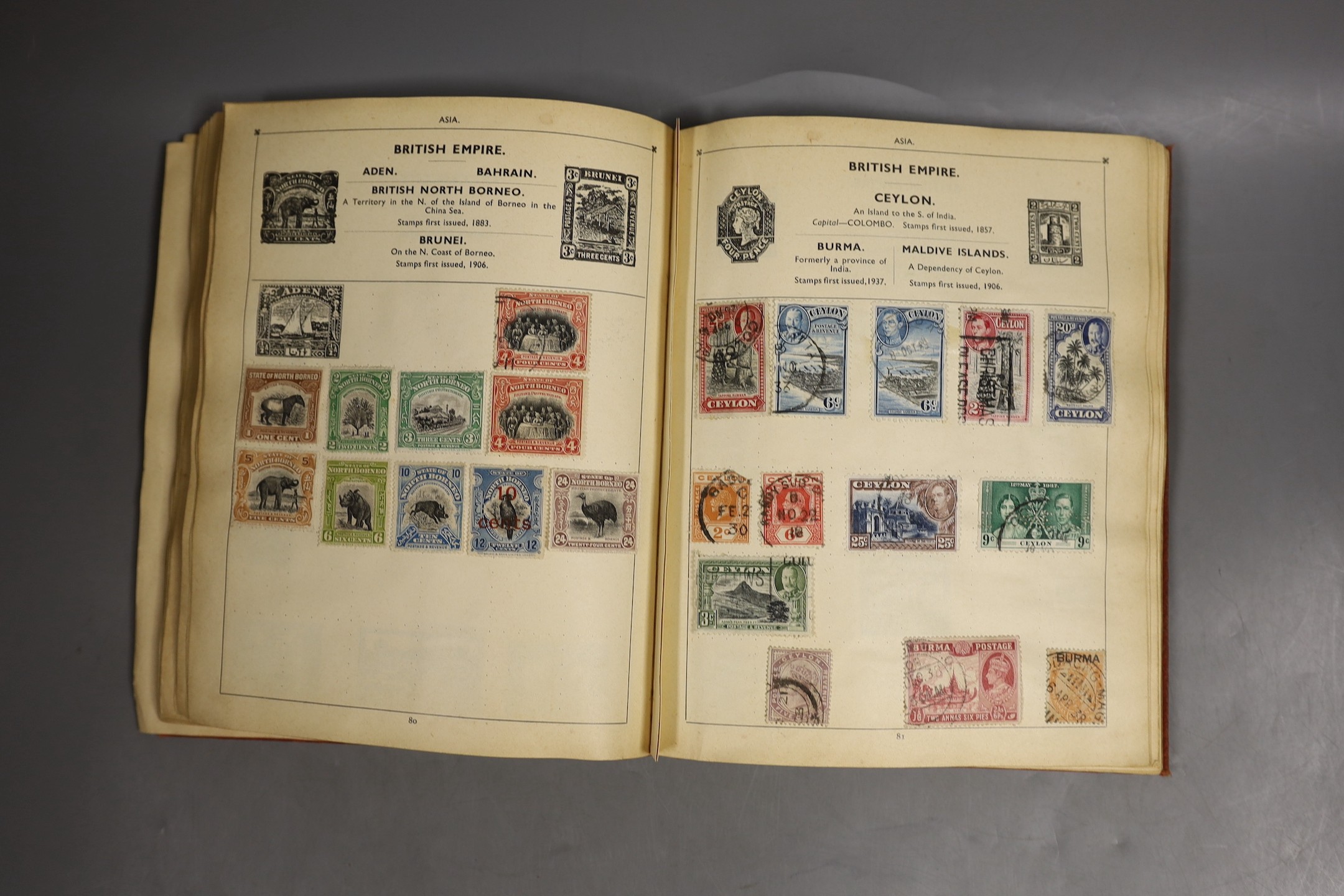 A stamp album of world stamps and a collection of loose stamps.